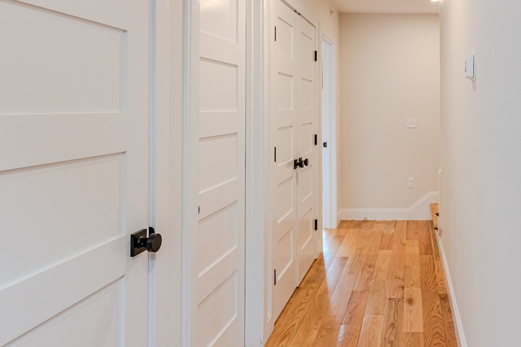1-7 Wilcutt Road, Unit 5 Boston, MA 02121 - Photo 12 of 24 a view of a hallway with wooden floor and staircase