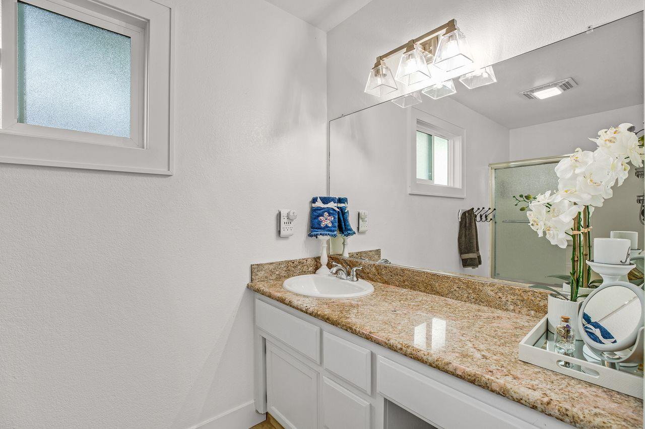 17745 Park Way Morgan Hill, CA 95037 - Photo 20 of 36 a bathroom with a granite countertop sink and a mirror