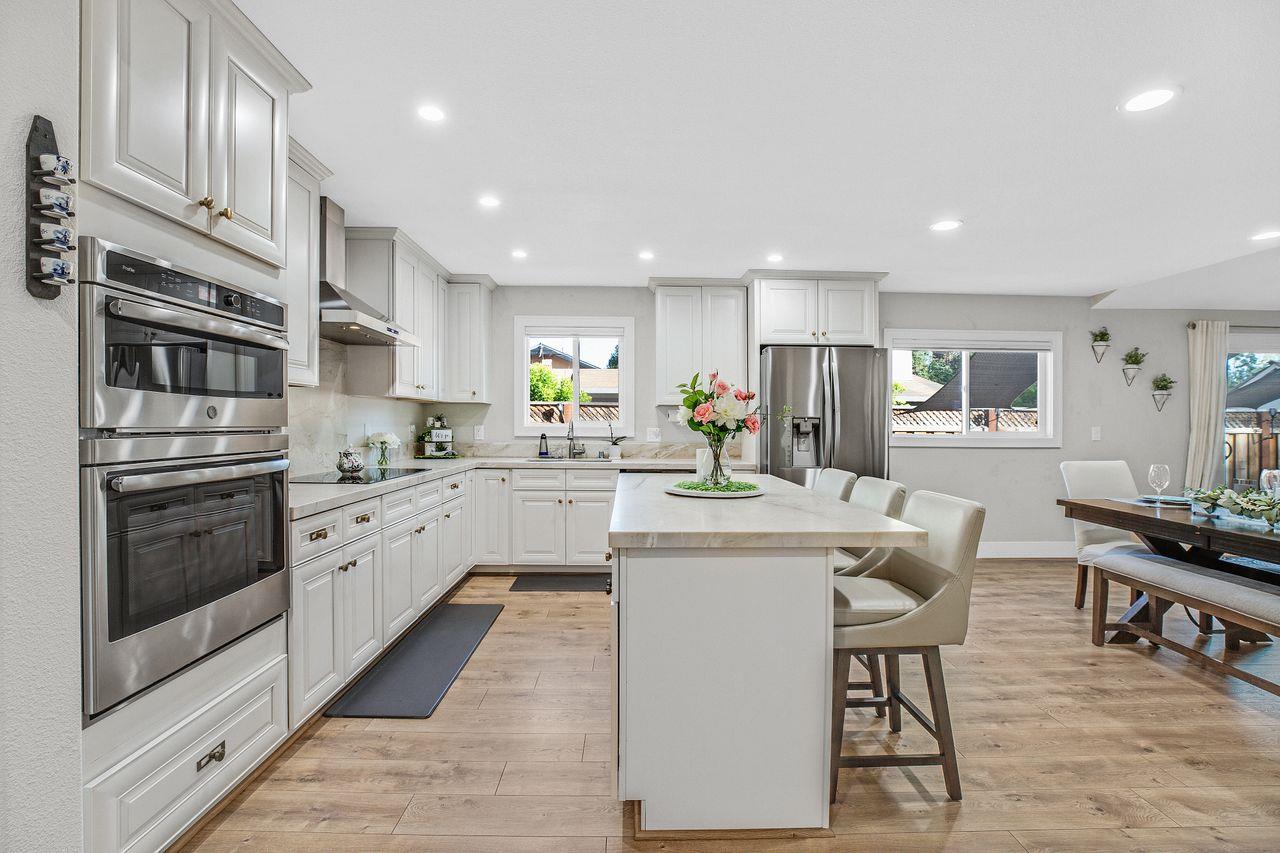 17745 Park Way Morgan Hill, CA 95037 - Photo 5 of 36 a kitchen with stainless steel appliances kitchen island granite countertop a stove top oven a sink dishwasher and a refrigerator