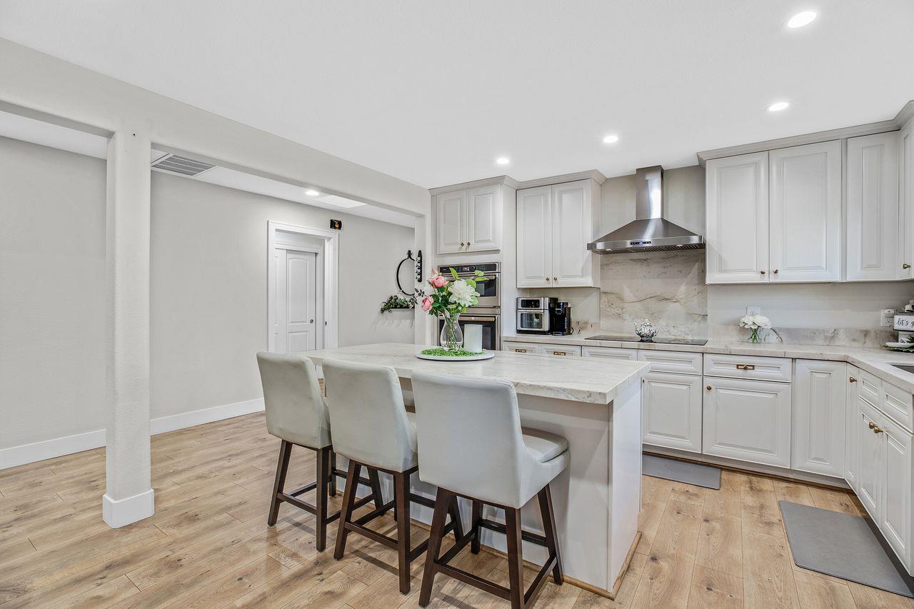 17745 Park Way Morgan Hill, CA 95037 - Photo 8 of 36 a kitchen with stainless steel appliances granite countertop a table chairs sink and cabinets