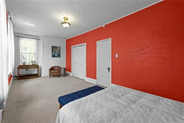 a bedroom with a bed and a couch