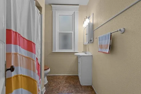 a bedroom with a bed and a mirror