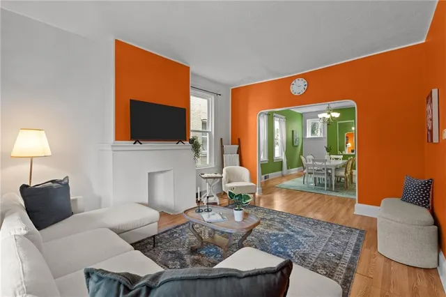 a living room with furniture a fireplace and a flat screen tv