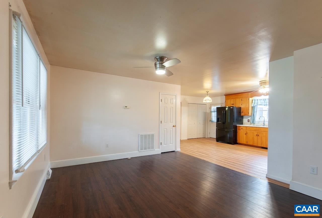 1358 Craigtown Road Shipman, VA 22971 - Photo 10 of 38 an empty room with wooden floor and a kitchen