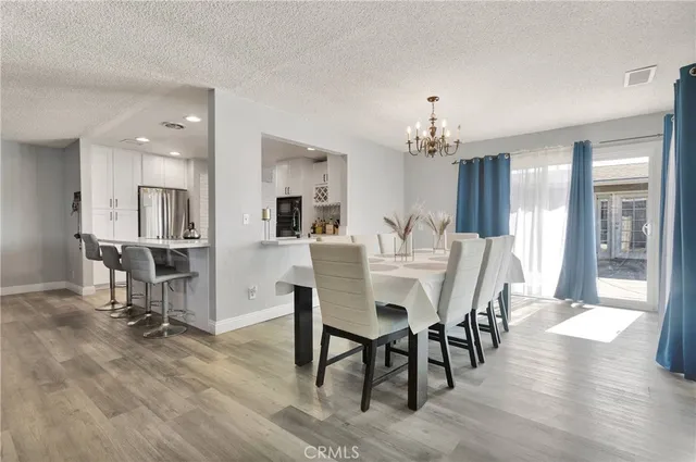 a view of a dining room with furniture and a chandelier
