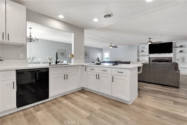 a kitchen with a sink cabinets and wooden floor