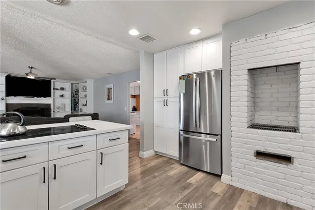 a kitchen with a refrigerator and a microwave