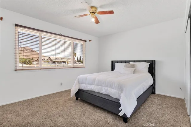 a spacious bedroom with a bed and window