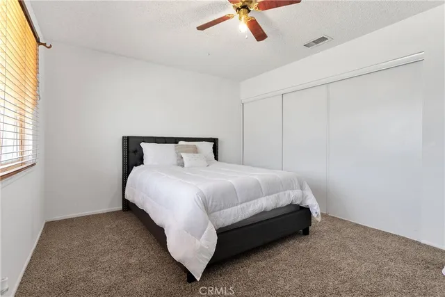 a bedroom with a bed and window