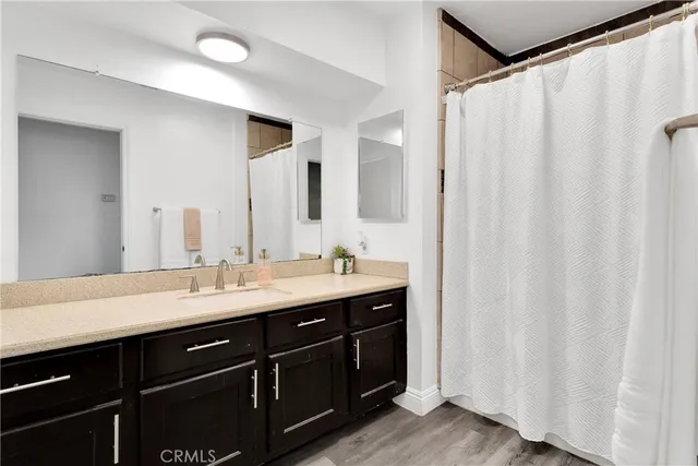 a bathroom with a double vanity sink and mirror