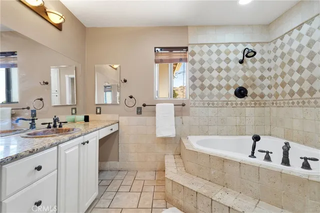 a white bath tub sitting next to a white toilet and a shower