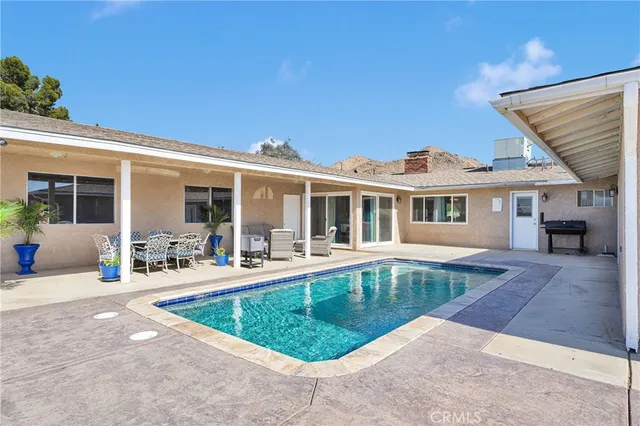 a view of a swimming pool with a lounge chair