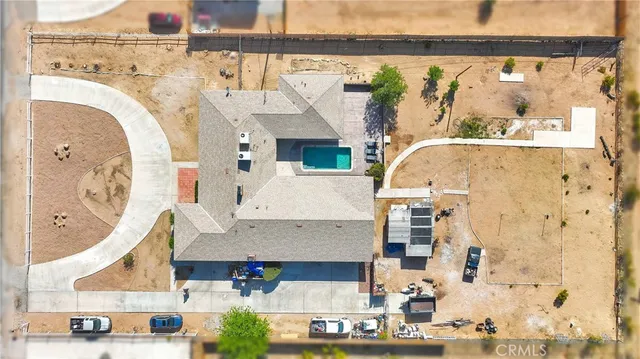 an aerial view of a house with a yard