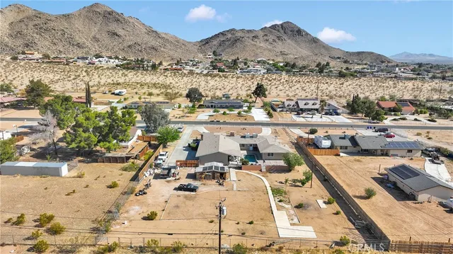 an aerial view of a residential houses with outdoor space