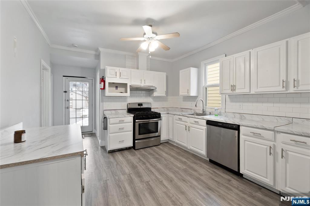 580 Monroe Avenue, Unit 1 Elizabeth, NJ 07201 - Photo 3 of 10 a kitchen with a white cabinets and window