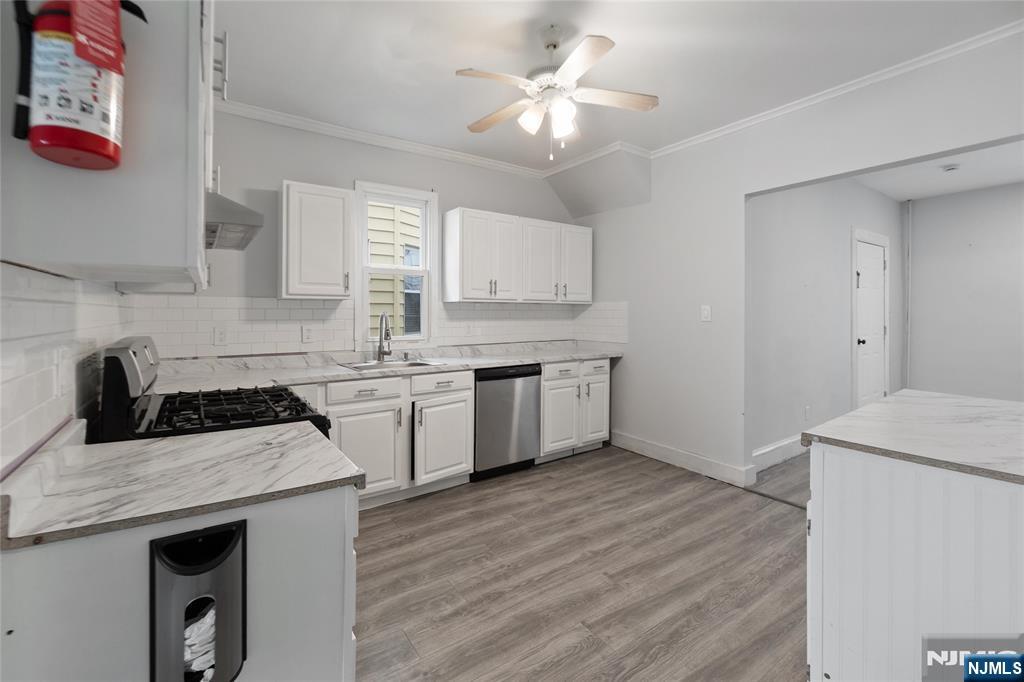 580 Monroe Avenue, Unit 1 Elizabeth, NJ 07201 - Photo 4 of 10 a kitchen with a stove a sink and a refrigerator