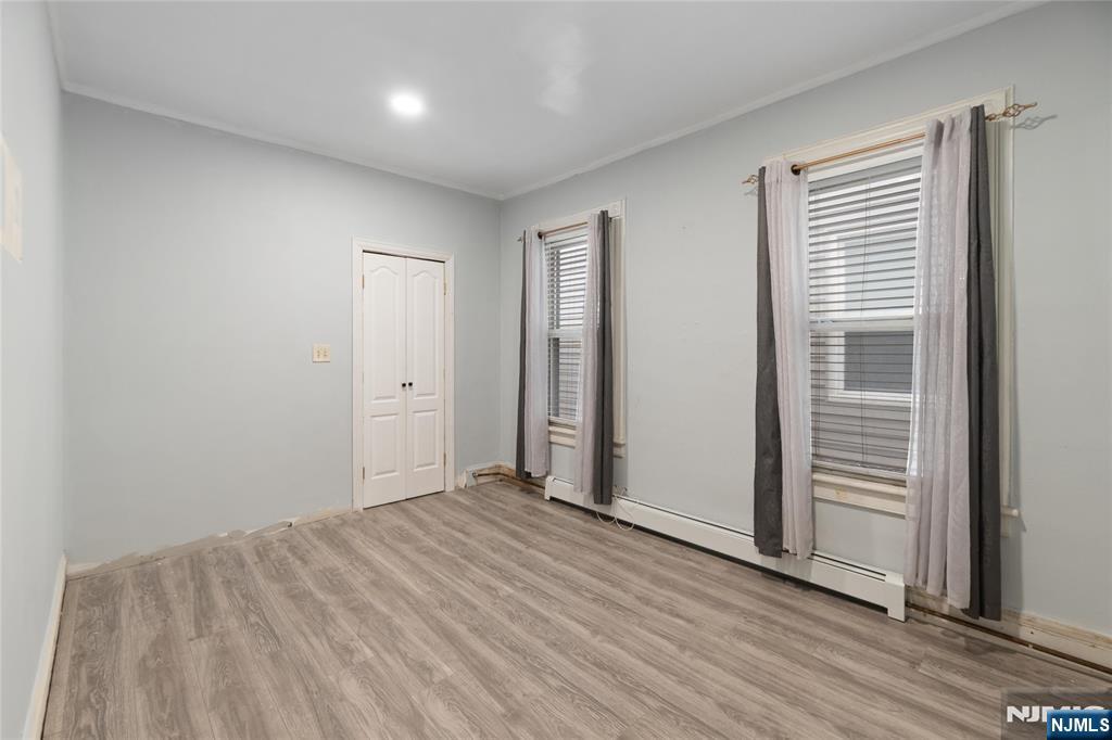 580 Monroe Avenue, Unit 1 Elizabeth, NJ 07201 - Photo 6 of 10 an empty room with wooden floor and windows