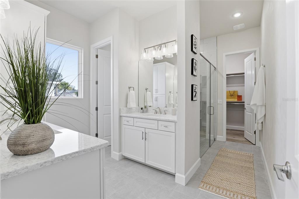 13425 Southwest 9th Road Newberry, FL 32669 - Photo 17 of 46 a bathroom with a granite countertop sink a mirror and a shower