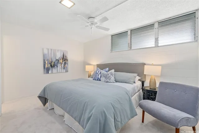 a bedroom with a bed and lamp