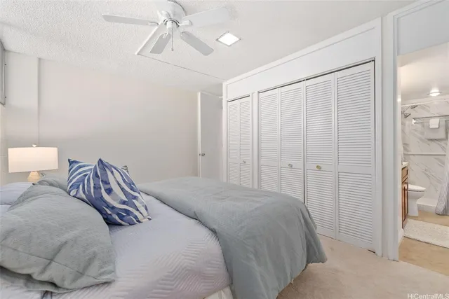 a bedroom with a bed and a painting on the wall