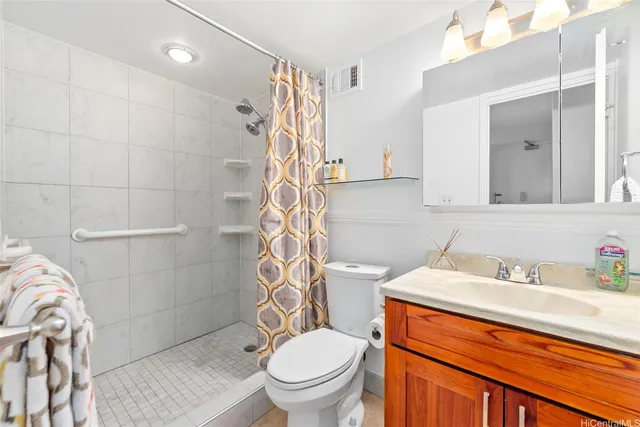 a bathroom with a sink a toilet and shower curtain