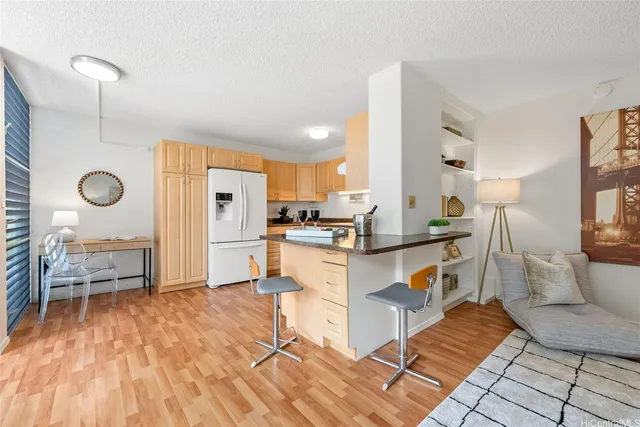 a kitchen with a sink cabinets and wooden floor