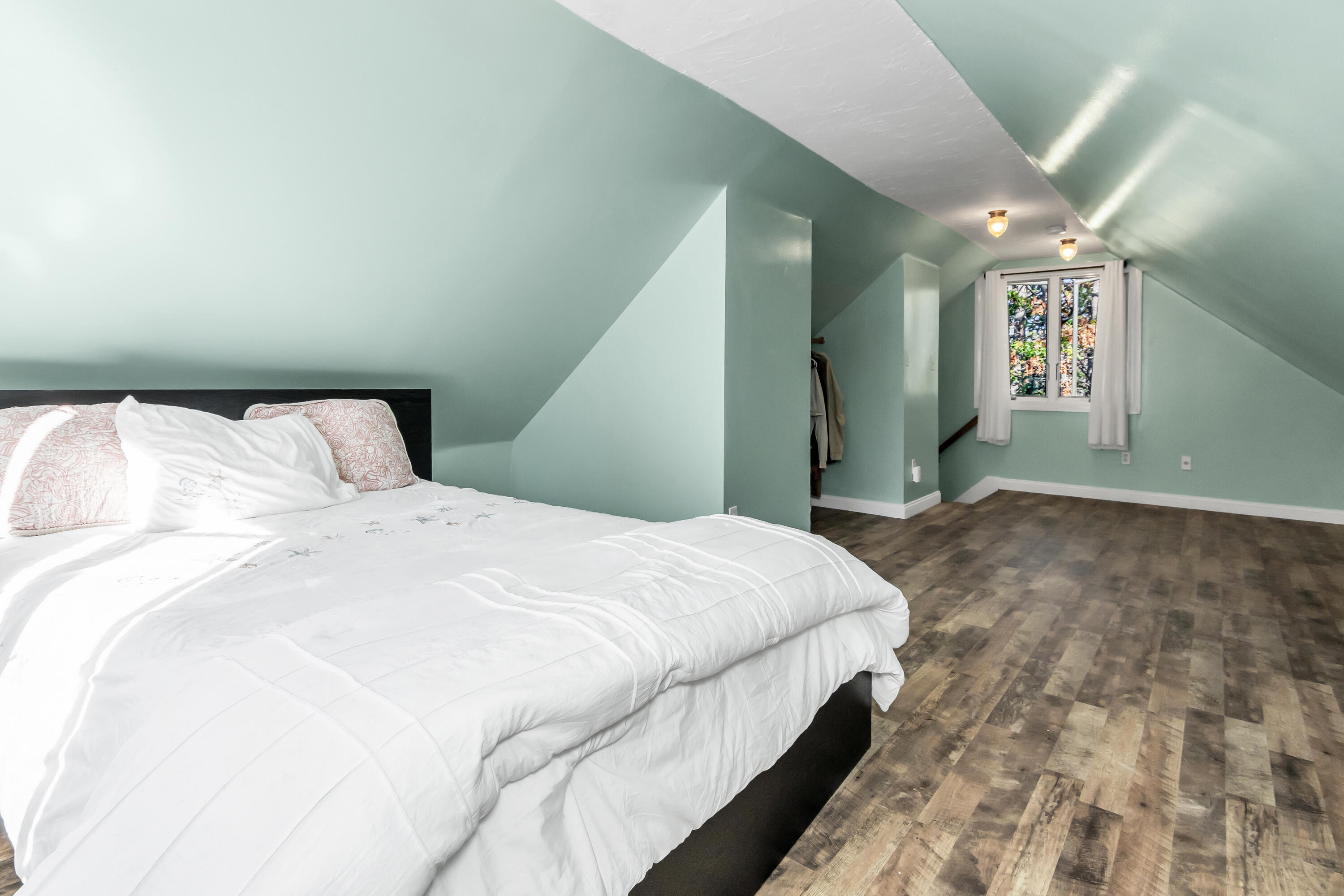 76 Trout Brook Road Mashpee, MA 02649 - Photo 29 of 43 a bedroom with a bed and a chandelier