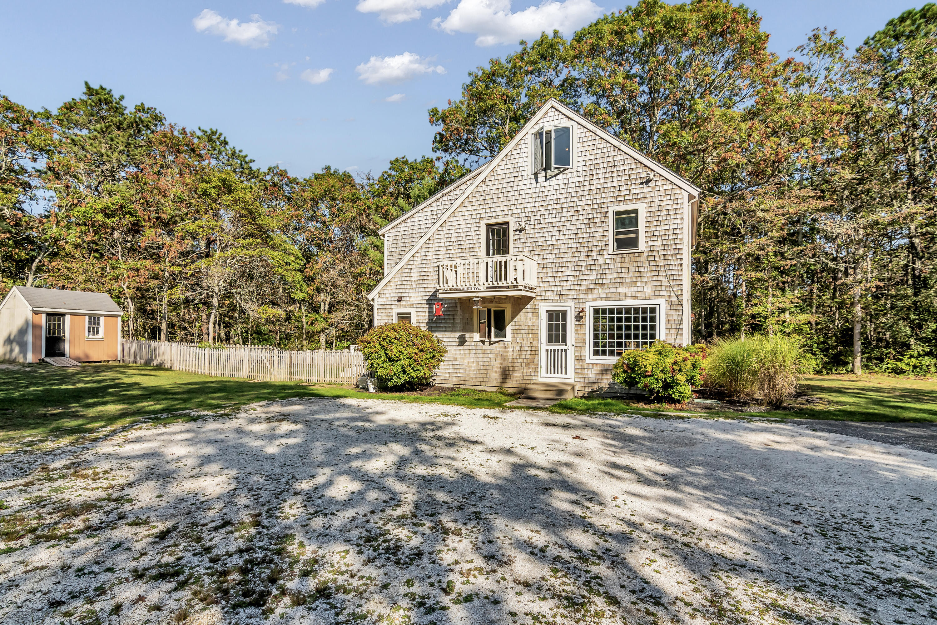 76 Trout Brook Road Mashpee, MA 02649 - Photo 5 of 43 a front view of a house with a yard