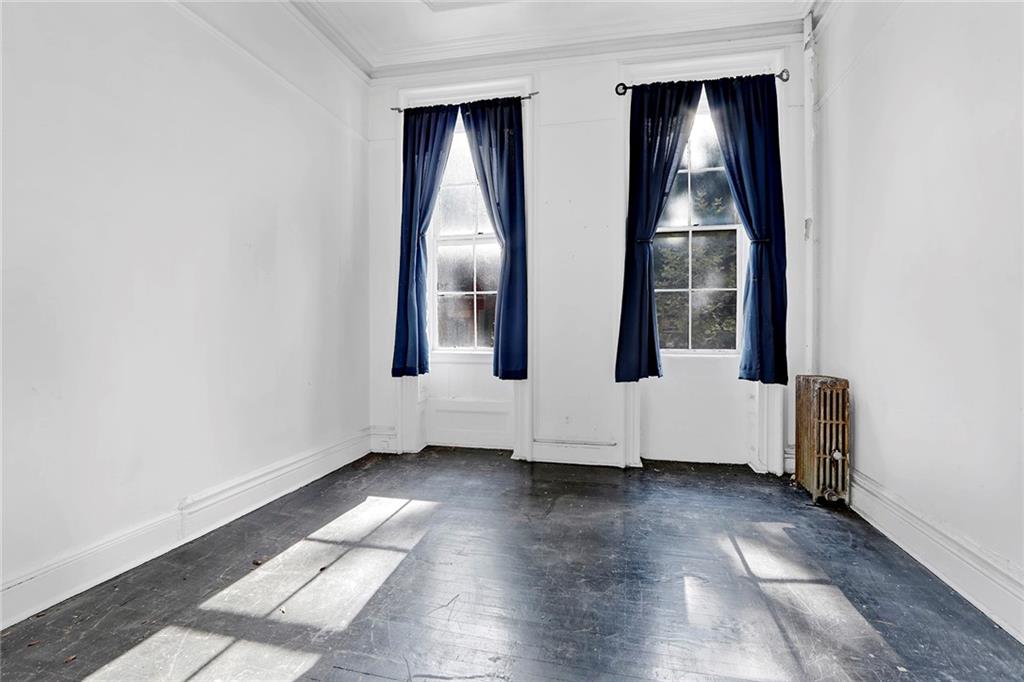 398 Henry Street Brooklyn, NY 11201 - Photo 12 of 14 an empty room with wooden floor and windows