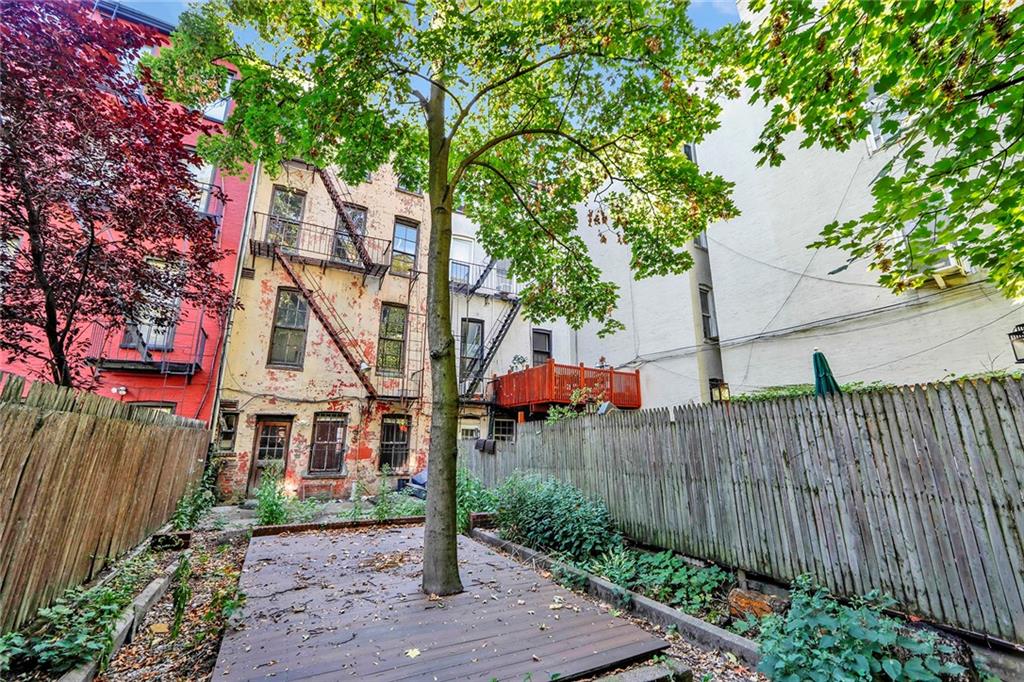 398 Henry Street Brooklyn, NY 11201 - Photo 2 of 14 a view of a park with a tree and wooden fence