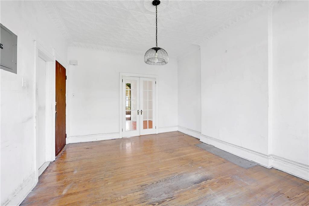 398 Henry Street Brooklyn, NY 11201 - Photo 4 of 14 a view of an empty room with window and wooden floor
