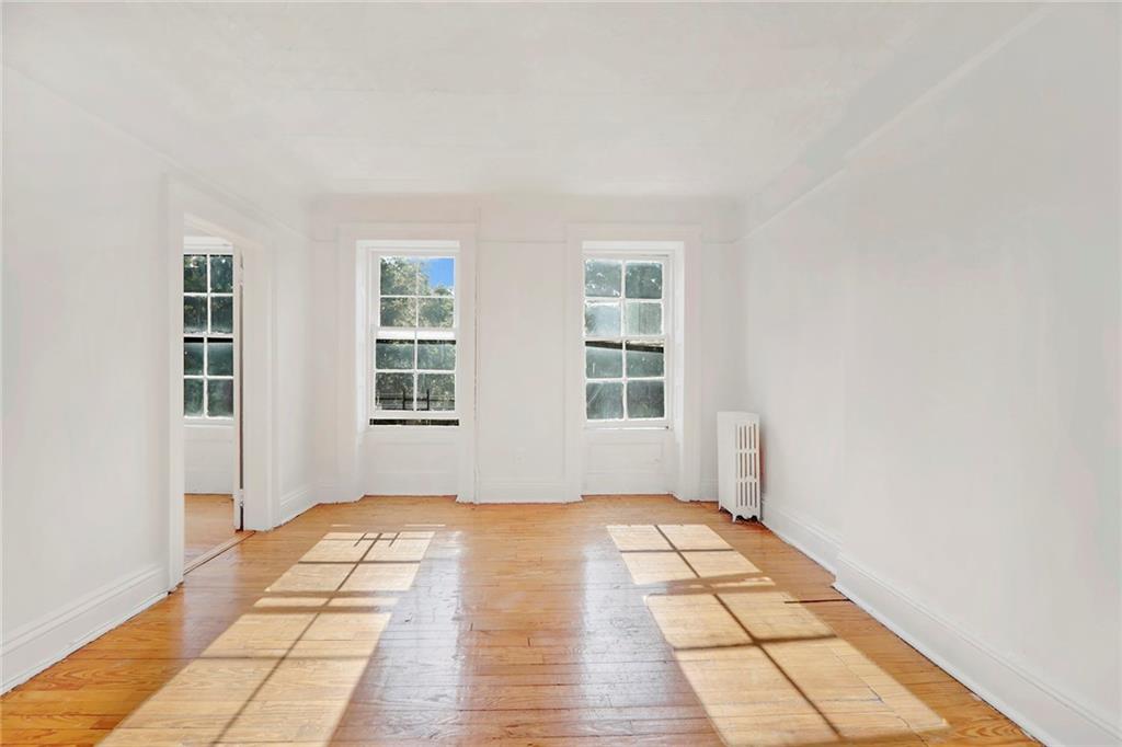 398 Henry Street Brooklyn, NY 11201 - Photo 5 of 14 a view of a room with wooden floor and windows