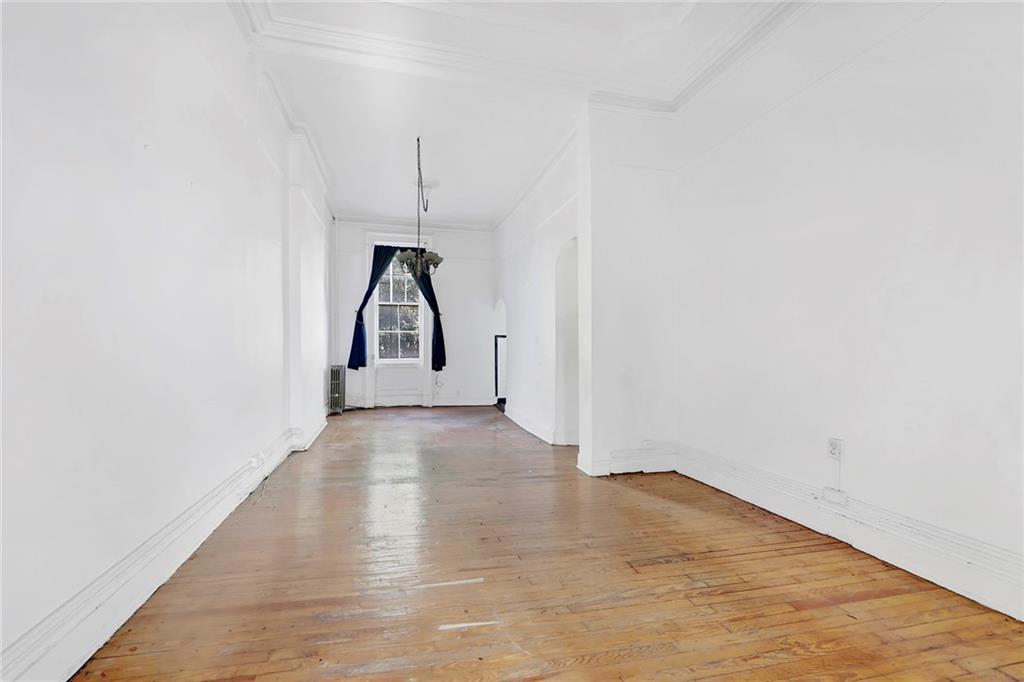 398 Henry Street Brooklyn, NY 11201 - Photo 7 of 14 a view of a room with wooden floor and white walls