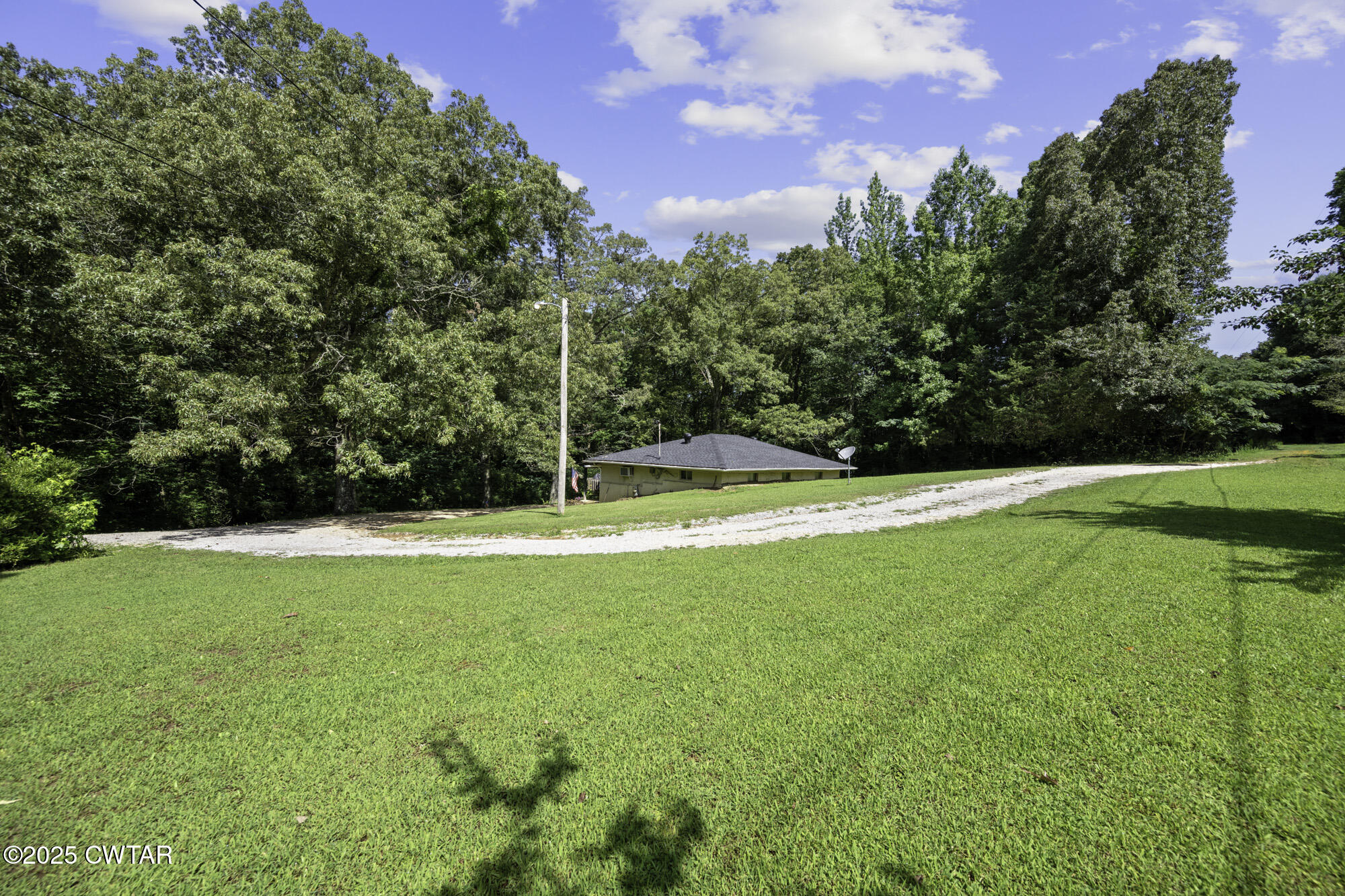 185 Corinth Road Darden, TN 38328 - Photo 2 of 8 a view of yard with swimming pool and green space