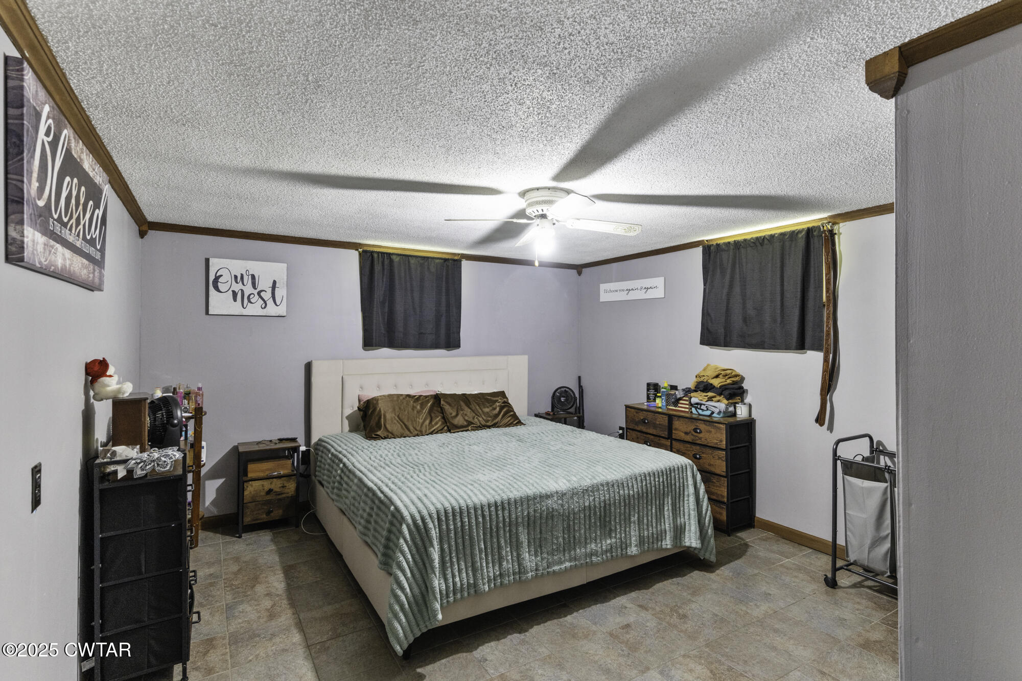 185 Corinth Road Darden, TN 38328 - Photo 4 of 8 a bedroom with a bed and a chandelier