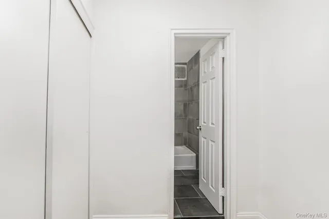 a view of a bathroom from a corridor