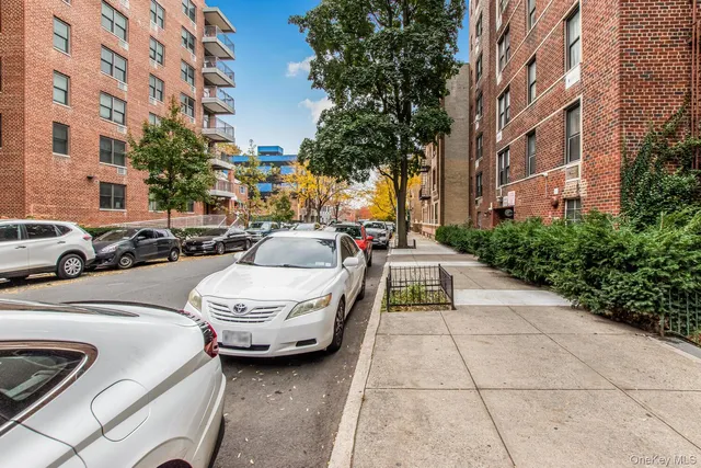 a view of a cars park in front of a building