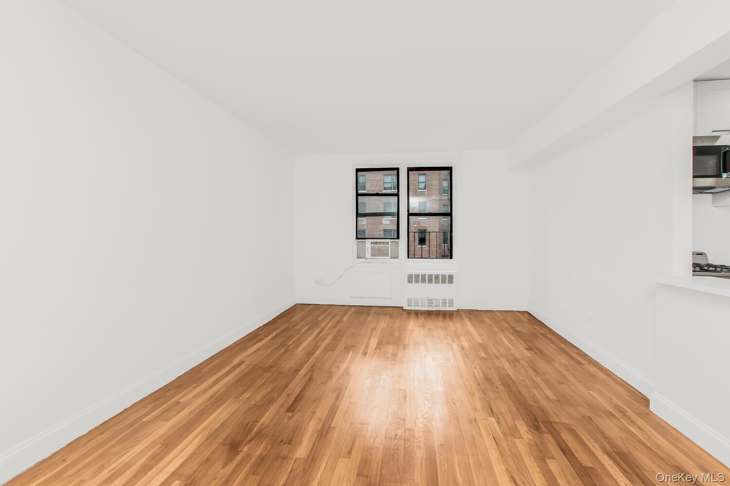 2165 Matthews Avenue, Unit 4B Bronx, NY 10462 - Photo 7 of 16 a view of a room with wooden floor and window
