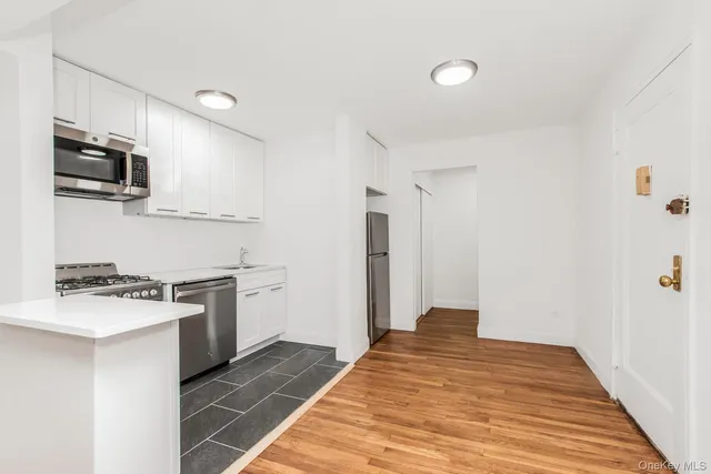 a kitchen with stainless steel appliances granite countertop a stove and a refrigerator