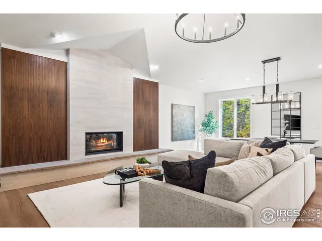 a living room with furniture a flat screen tv and a table