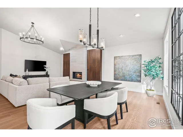 a living room with furniture a flat screen tv and a large window