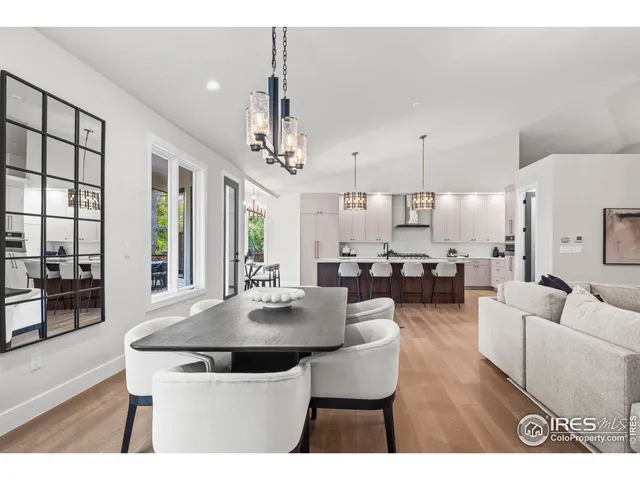 a kitchen with a dining table chairs and white cabinets