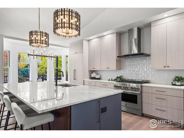 a kitchen with stainless steel appliances granite countertop a sink and a stove