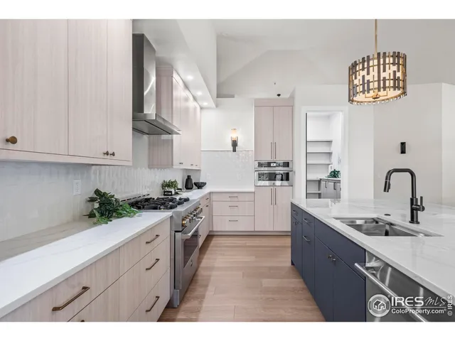 a kitchen with stainless steel appliances kitchen island granite countertop a table chairs sink and cabinets