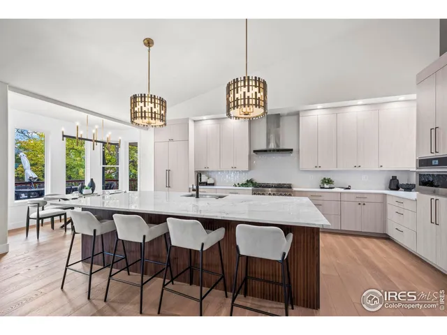 a kitchen with stainless steel appliances a refrigerator and a stove top oven