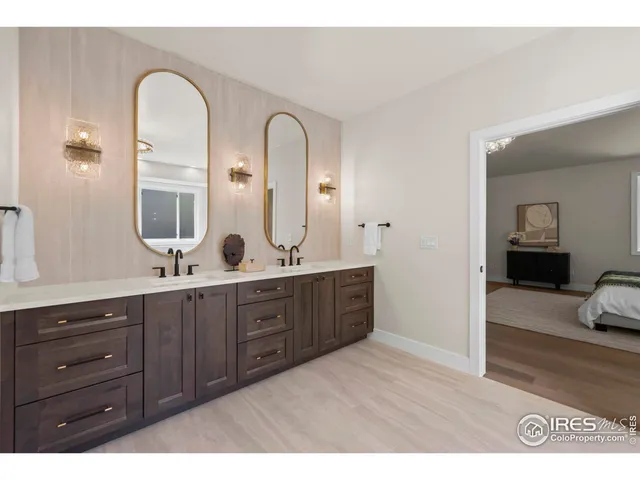 a bathroom with a tub a sink and mirror