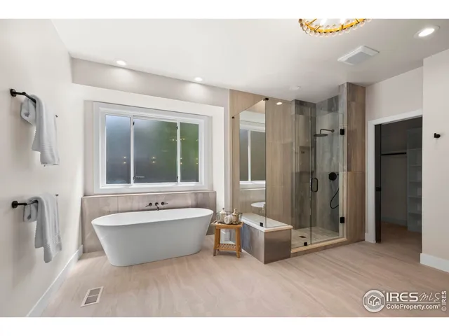 a spacious bathroom with a bathtub shower and sink