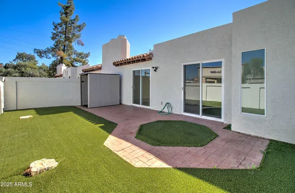a kitchen with a refrigerator a sink and white cabinets