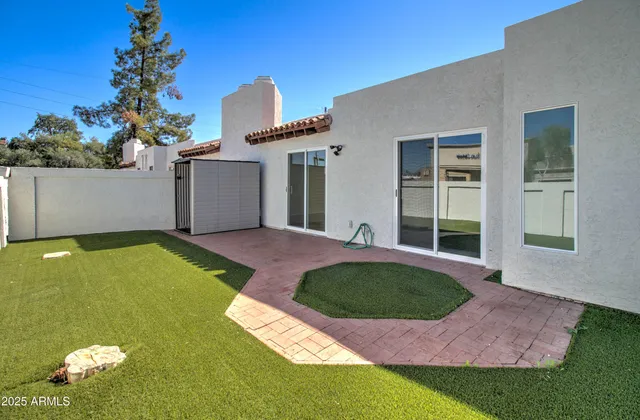 a kitchen with a refrigerator a sink and white cabinets