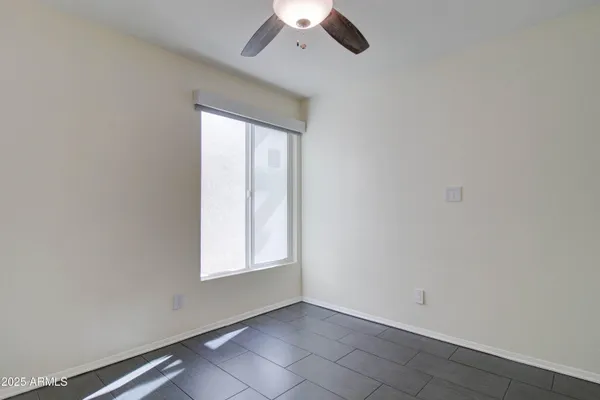 a view of a room with a hanging light and kitchen